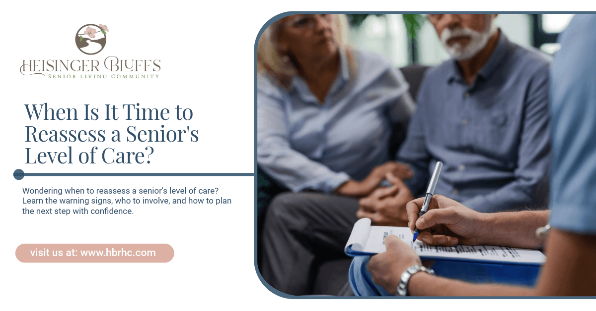 A caregiver talking to a senior couple while writing on a paper